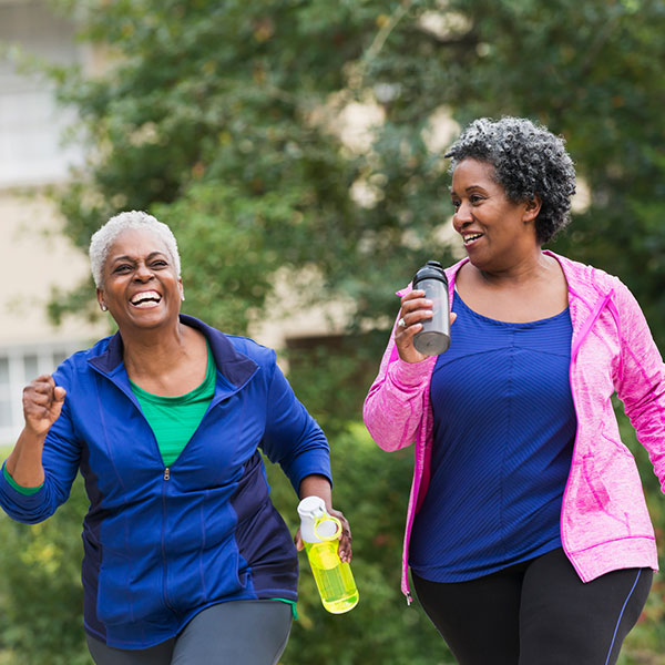 two happy woman running